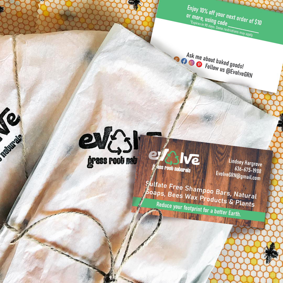Evolve Grass Roots Naturals business card is tucked under a twine wrapping a package. The back of the business card is seen under the packages.